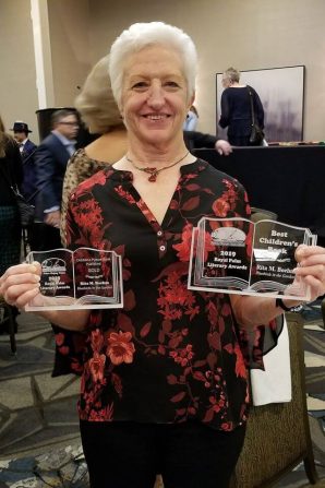 Author Rita M. Boehm with award plaques